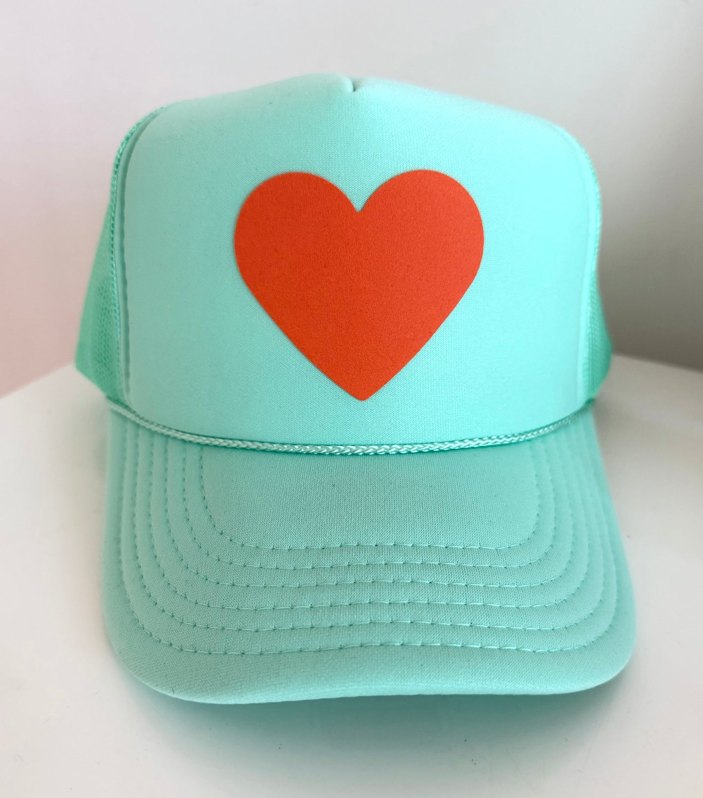 Orange heart 🧡 on mint green hat (The Life of a Showgirl colors)