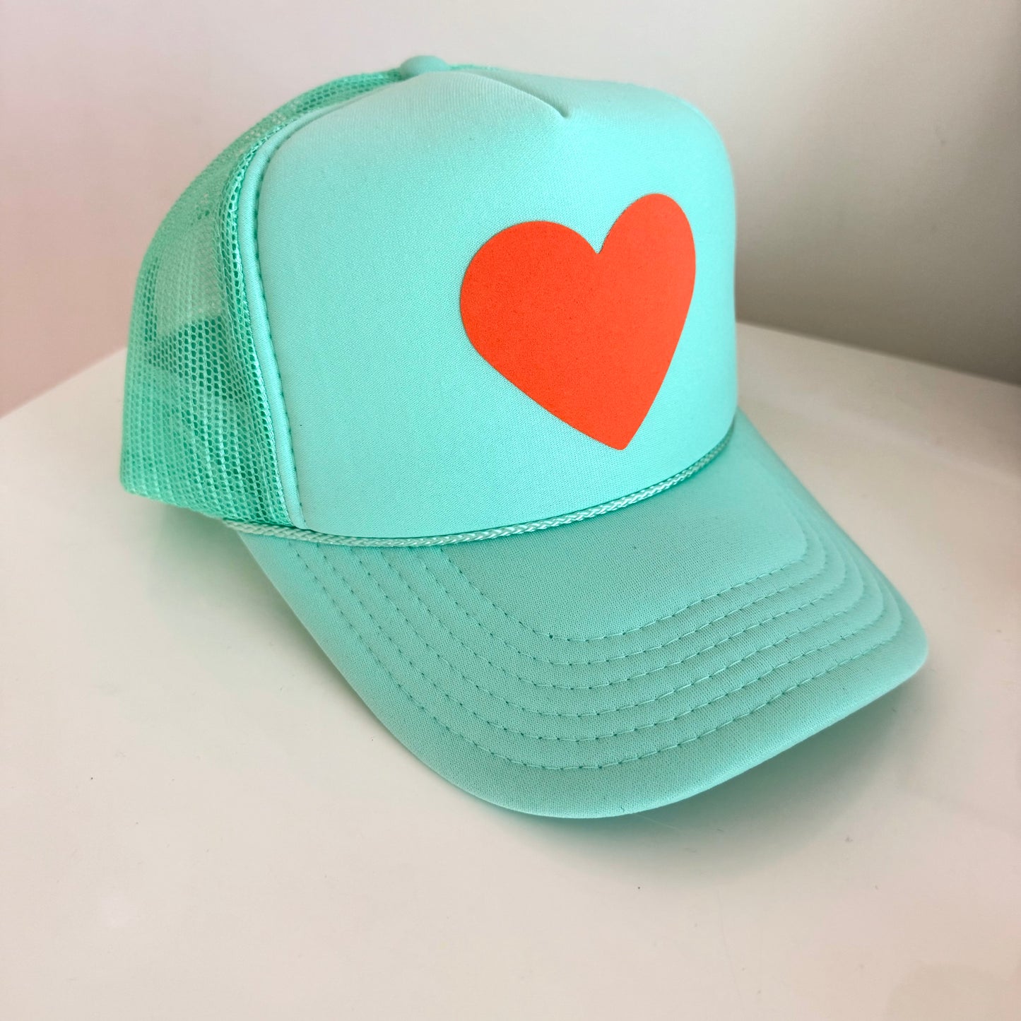 Orange heart 🧡 on mint green hat (The Life of a Showgirl colors)